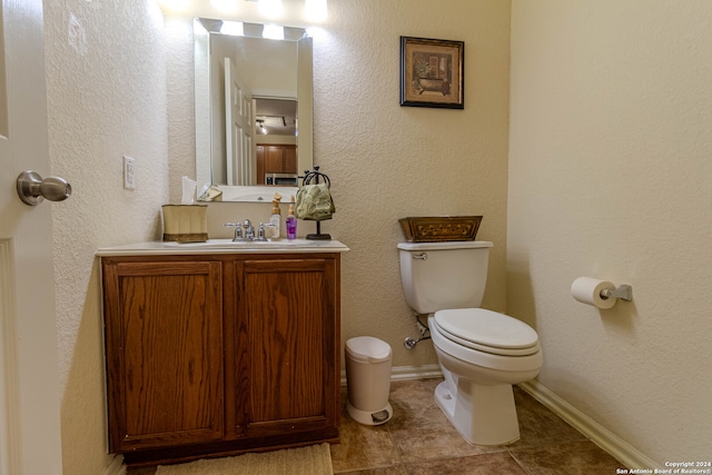 bathroom featuring vanity, toilet, and tile patterned floors