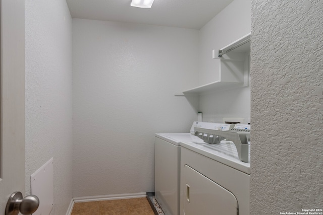 laundry area featuring washer and dryer and light tile patterned flooring