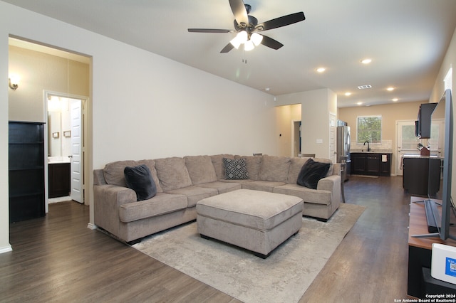 living room with ceiling fan, sink, and dark hardwood / wood-style floors