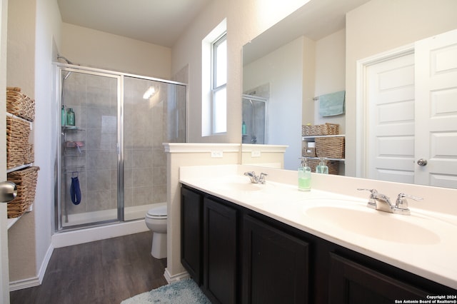 bathroom with vanity, hardwood / wood-style floors, toilet, and walk in shower