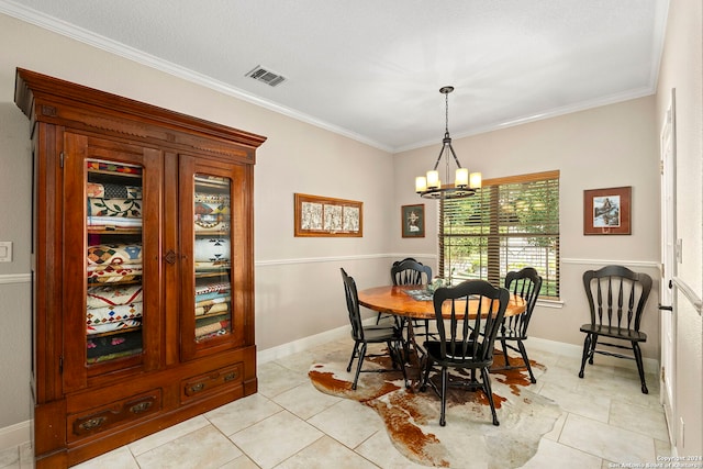 dining area featuring light tile patterned flooring, crown molding, a textured ceiling, and a chandelier