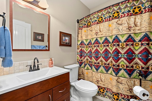 bathroom with backsplash, vanity, and toilet