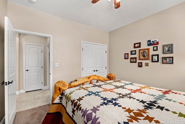 bedroom featuring light tile patterned floors, a closet, and ceiling fan