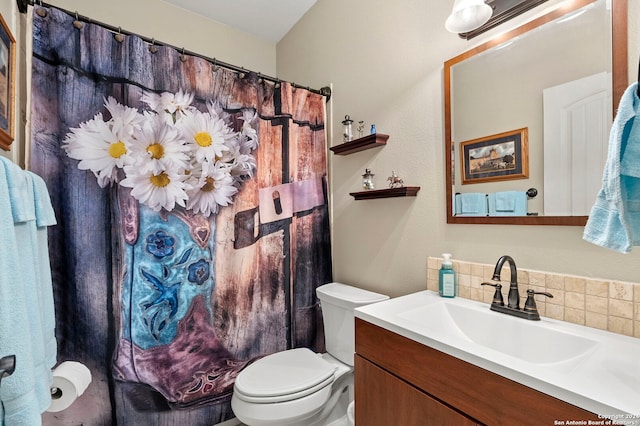 bathroom with toilet, tasteful backsplash, and vanity