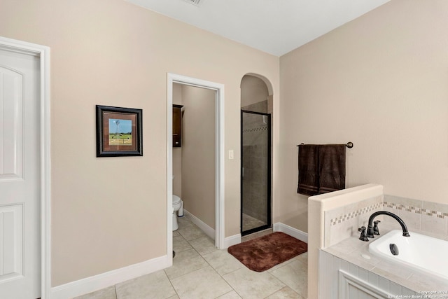 bathroom featuring toilet, plus walk in shower, and tile patterned flooring