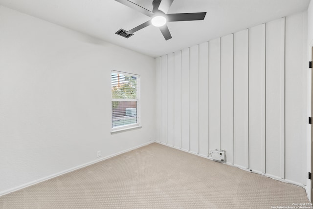 carpeted spare room with ceiling fan