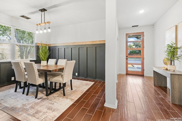 dining room featuring a notable chandelier, plenty of natural light, and dark hardwood / wood-style flooring