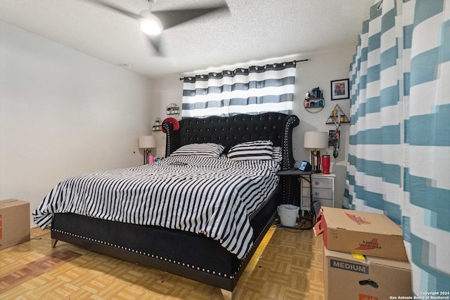 bedroom with parquet flooring, a textured ceiling, and ceiling fan