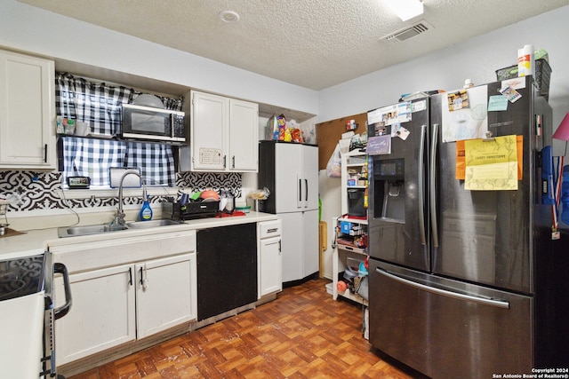 kitchen featuring sink, white cabinetry, decorative backsplash, and stainless steel appliances