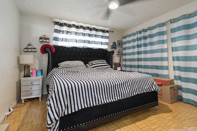 bedroom with a textured ceiling and light parquet flooring