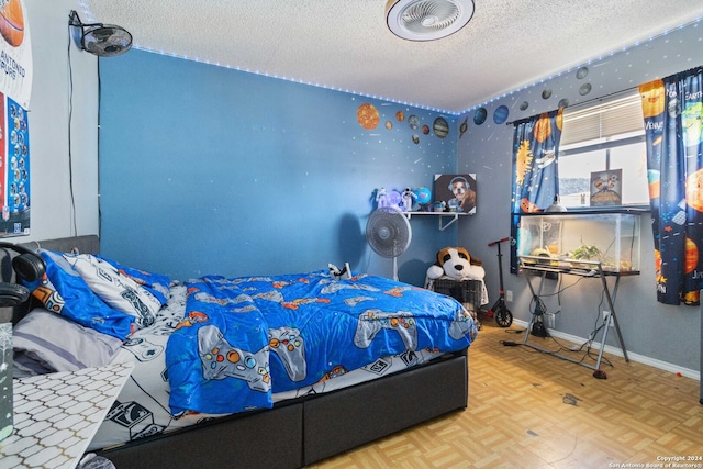 bedroom with a textured ceiling and parquet floors