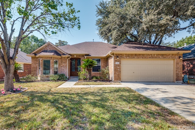 single story home with a front yard and a garage