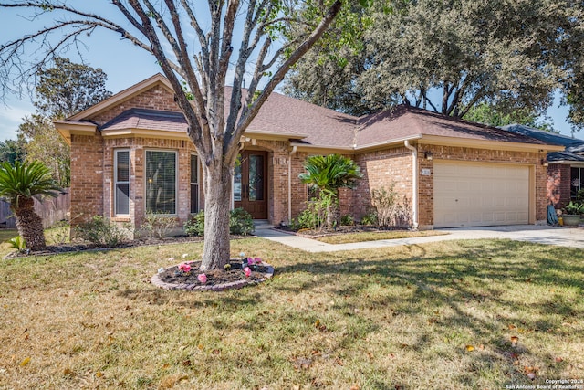 ranch-style house featuring a garage and a front lawn