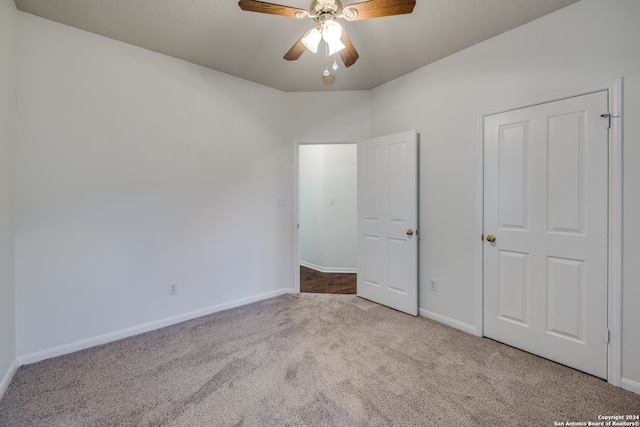 unfurnished bedroom with light colored carpet and ceiling fan