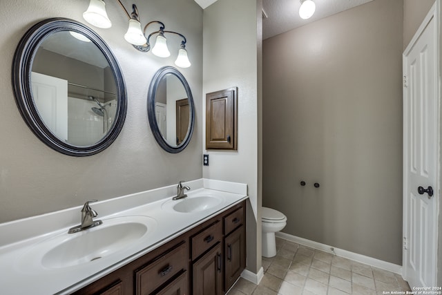 bathroom with vanity, a shower, and toilet