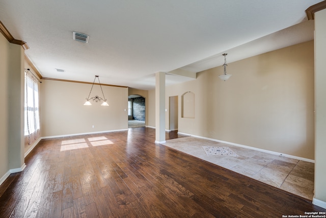 unfurnished living room with crown molding and wood-type flooring