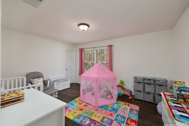 bedroom with dark hardwood / wood-style flooring