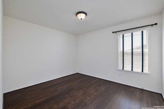 unfurnished room featuring dark hardwood / wood-style flooring