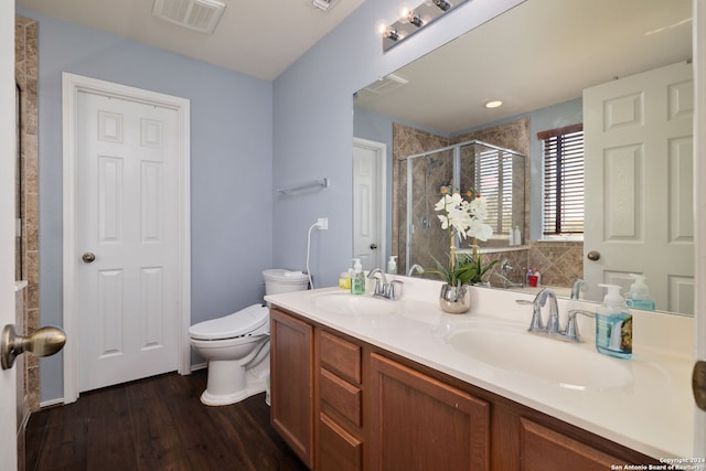 bathroom with vanity, a shower with shower door, wood-type flooring, and toilet