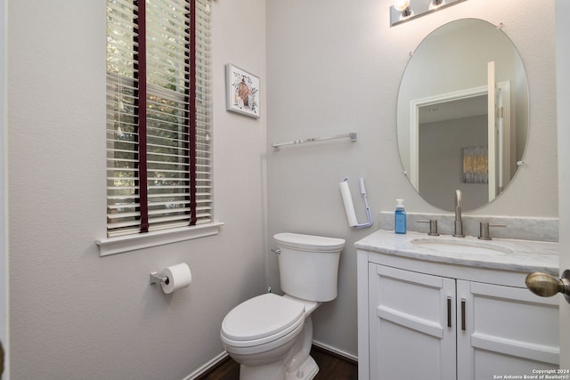 bathroom with vanity, hardwood / wood-style floors, and toilet