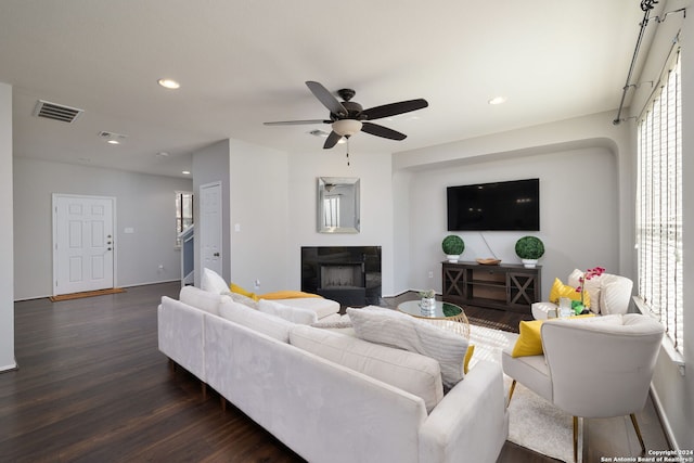 living room featuring ceiling fan and dark hardwood / wood-style flooring