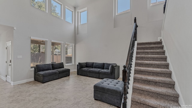 living room featuring a wealth of natural light and a high ceiling