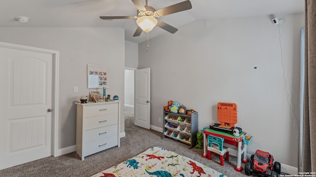 recreation room featuring vaulted ceiling, dark colored carpet, and ceiling fan