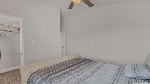 carpeted bedroom with lofted ceiling, a closet, and ceiling fan