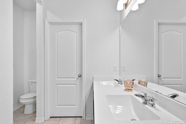 bathroom featuring vanity, tile patterned floors, and toilet