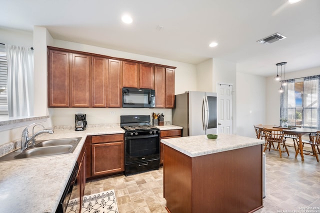 kitchen with hanging light fixtures, a kitchen island, a chandelier, black appliances, and sink