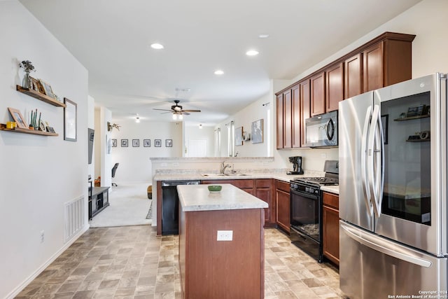 kitchen with a center island, a sink, black appliances, ceiling fan, and a peninsula