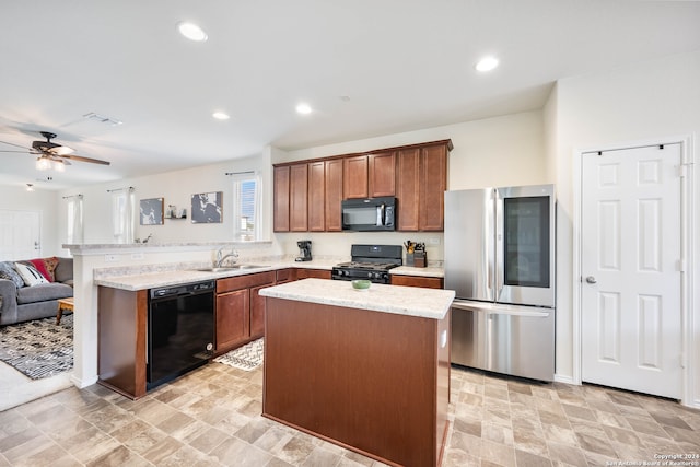 kitchen featuring a kitchen island, kitchen peninsula, sink, black appliances, and ceiling fan