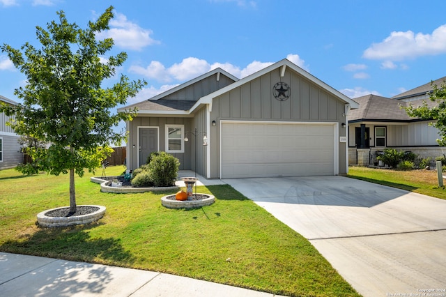 view of front of home with a garage and a front lawn