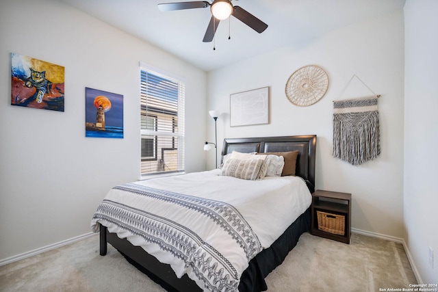 carpeted bedroom with baseboards and a ceiling fan