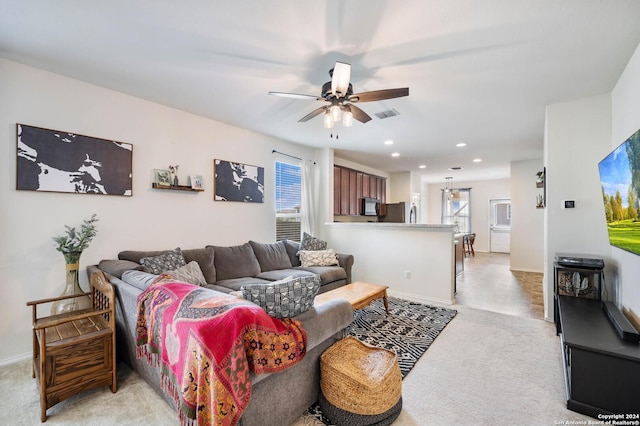 living room with visible vents, baseboards, recessed lighting, light colored carpet, and a ceiling fan