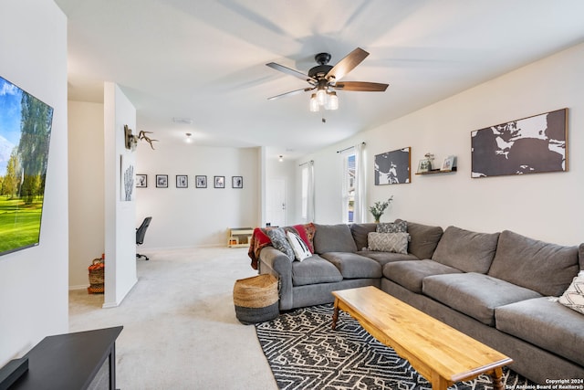 carpeted living room with ceiling fan