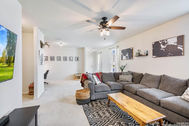 living area with a ceiling fan and light colored carpet