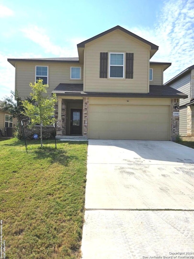 front of property featuring a front yard and a garage