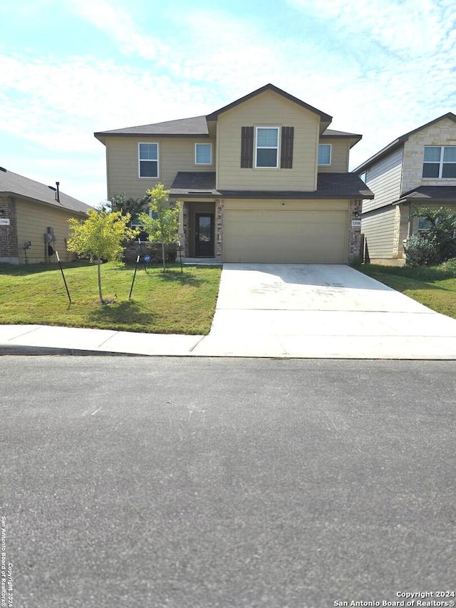 front of property featuring a front yard and a garage