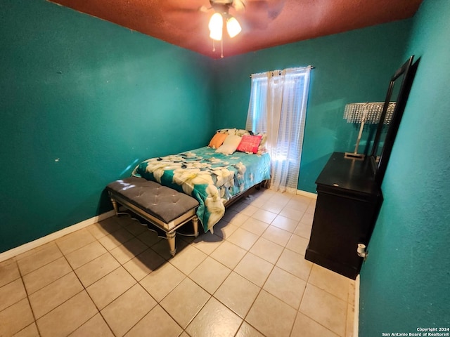 tiled bedroom featuring ceiling fan