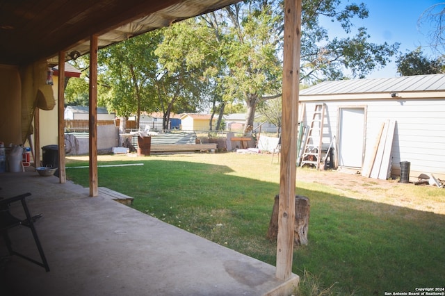 view of yard with a storage shed and a patio