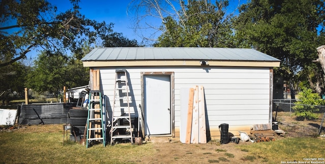 view of outbuilding featuring a yard