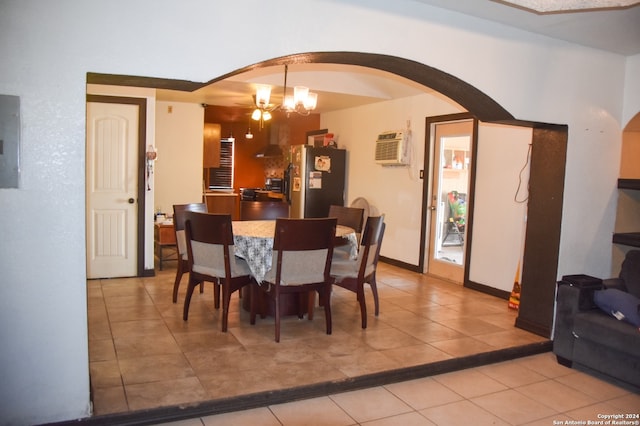 tiled dining space with a chandelier, electric panel, and a wall mounted air conditioner