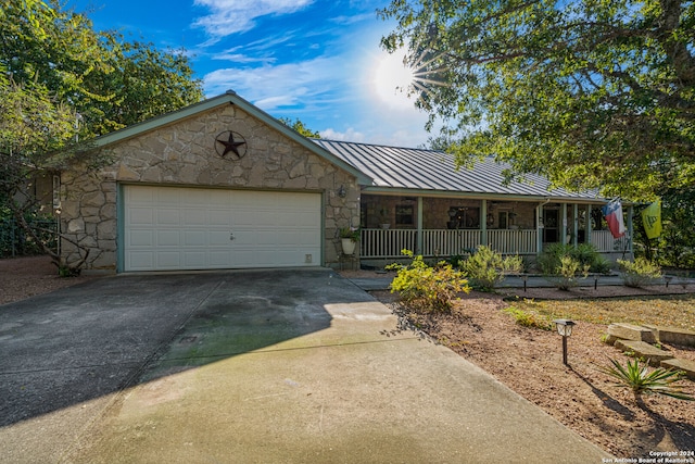 ranch-style house with a porch and a garage