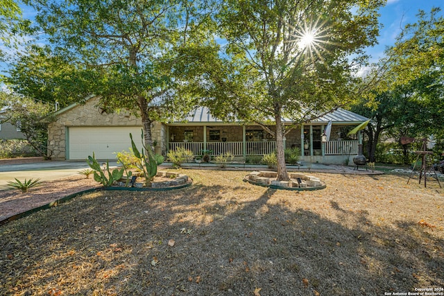 ranch-style home with covered porch and a garage