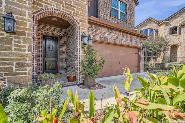 view of exterior entry with a garage