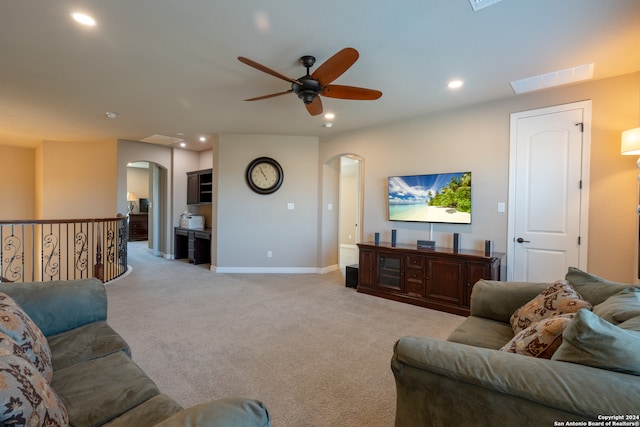 living room featuring light colored carpet and ceiling fan