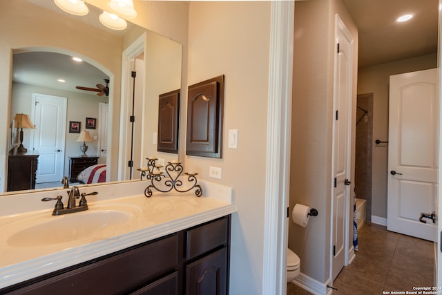 full bathroom featuring separate shower and tub, ceiling fan, toilet, vanity, and tile patterned flooring