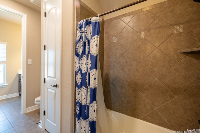 full bathroom featuring vanity, toilet, shower / bath combo with shower curtain, and tile patterned flooring