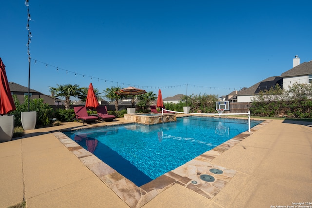 view of pool featuring an in ground hot tub and a patio